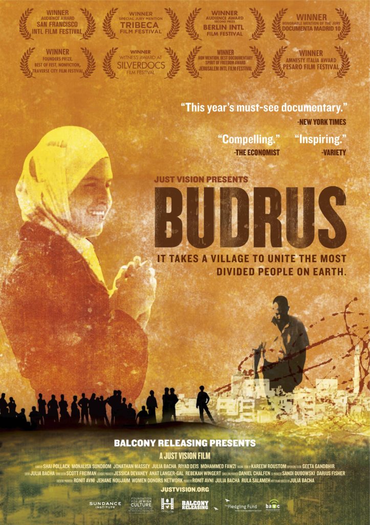 The image is a poster for the documentary film "Budrus." It shows a woman wearing a yellow headscarf, people holding hands, and a man planting a tree. The text highlights awards won by the film and quotes describing it as "compelling" and "inspiring." The tagline reads, "It takes a village to unite the most divided people on earth." Don't miss this powerful film