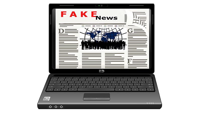 Illustration of an open laptop displaying a newspaper with the headline "FAKE News" in bold red letters on its screen. The screen shows stylized text, images, and graphics, vividly portraying how misinformation can undermine truth.