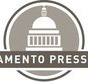 A logo with a gray circle containing a white silhouette of a domed building. Below the building, within the circle, is the text "SAMENTO PRESS." The first part of the text seems to be cropped. Perfect for institutions, students can identify SPC Scholarships with this clean, professional design.