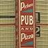 A vintage vertical sign with bold red, white, and blue lettering that reads "Picture-Pub and Pizza" highlights the intricate brickwork patterns on the building in the background.