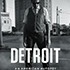 Black and white poster for the movie "Detroit" featuring a man standing with a serious expression, wearing a vest and tie. The cityscape of Detroit is visible in the background. The title "Detroit" is prominently displayed at the bottom, echoing themes found in LeDuff's New Book acclaimed by NY Times Reviews.