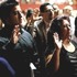 A group of people, possibly journalists, are standing with their right hands raised, some with solemn expressions. The setting appears to be an official ceremony, possibly a swearing-in or pledge. The background is blurred, focusing on the individuals in the foreground.