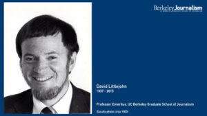 Black and white photograph of a man with a short beard and mustache, smiling. Text to the right reads: "David Littlejohn, 1937-2015, Professor Emeritus, UC Berkeley Graduate School of Journalism (J-School faculty photo circa 1963)." The top right corner shows the Berkeley Journalism logo.