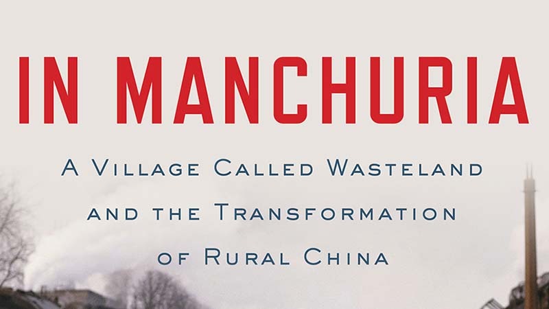 The image features the book cover for "In Manchuria: A Village Called Wasteland and the Transformation of Rural China" by Michael Meyer. The title is in large red letters, with the subtitle below in smaller blue text, set against a background with partial images of smoke and buildings, reflecting Meyer's detailed reporting.