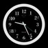 A round wall clock with a white frame and black face, featuring white numbers and hands, hangs on the wall. The time displayed is 10:09. It looks like something you might see in The Waiting Room, perhaps even a set piece from one of Pete Nicks' thought-provoking films shown in theaters.