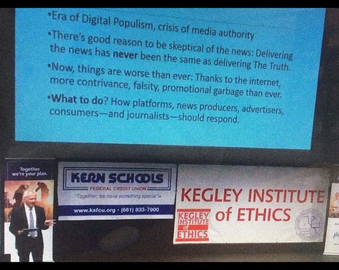 A speaker stands behind a podium giving a presentation on digital populism and media authority, with a slide displayed. Banners for "Kern Schools Federal Credit Union" and "Kegley Institute of Ethics" are visible. A logo for California State University is on the screen, highlighting insights from Berkeley Journalism.