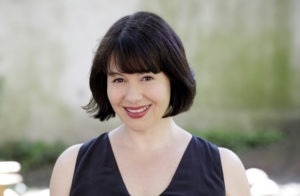 Image of Michelle Goldberg; short brown hair and black top with no sleeves.