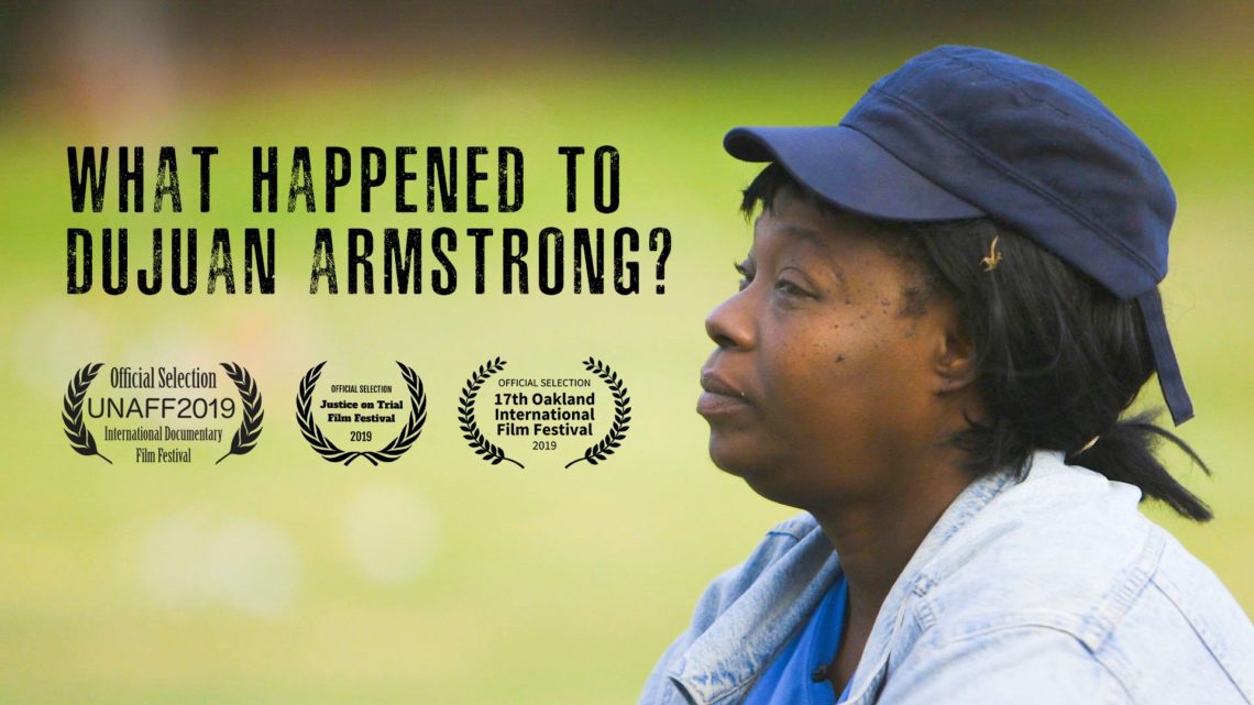 The image shows a person in profile wearing a dark cap and a gray hoodie, looking thoughtful or concerned. Text overlaid on the image reads, "What happened to Dujuan Armstrong?" and includes film festival laurels for UNAFF2019, Julien Dubuque International Film Festival 2019, and the 17th Oakland International Film Festival. A Berkeley Journalism production.