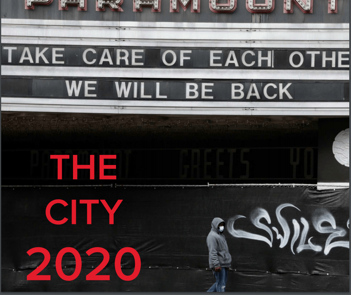 The image is labeled as "The City 2020". A man wearing a mask walks in front of a theatre that was closed off in 2020 during covid. There is a fence with graffiti and a Marquee banner that reads, "Take care of each other, we will be back." 