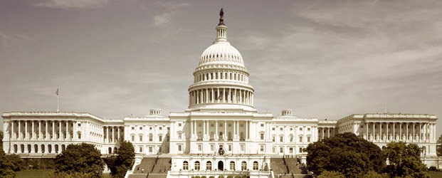 A sepia-toned image of the United States Capitol building in Washington, D.C. The domed structure is flanked by symmetrical wings, with a series of steps leading up to the entrance. Trees and a cloudy sky frame the historic government building, reminiscent of a Berkeley Journalism piece capturing history.