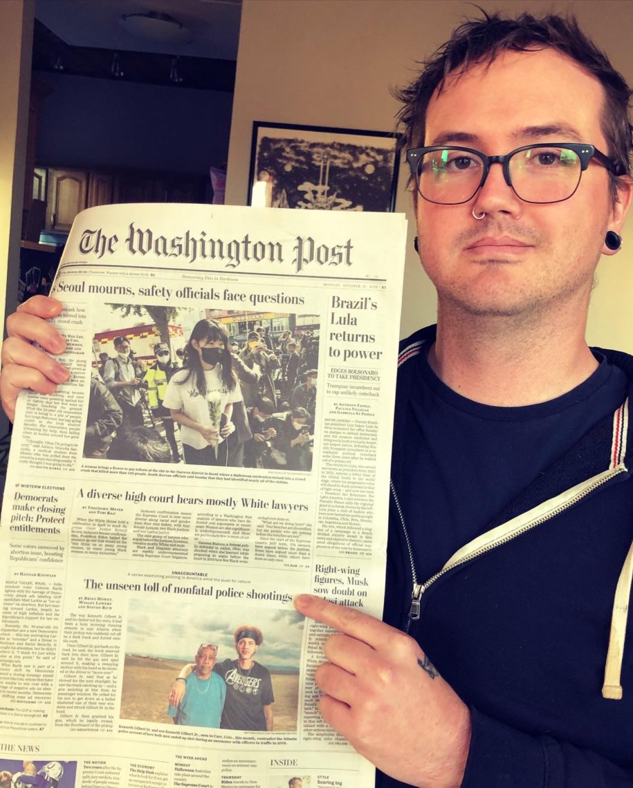 Journalism student holding news headline