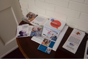 Photo of a table with informational handouts/pamphlets from ALTER