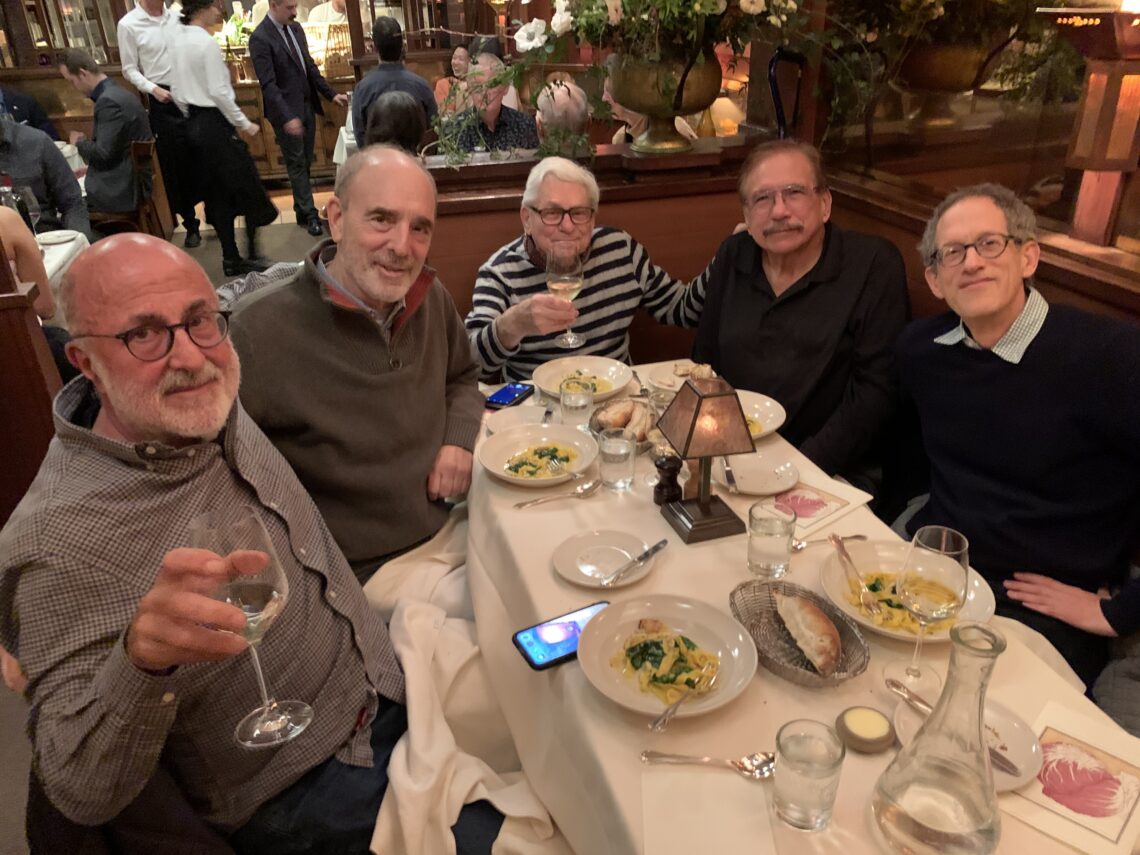 Group photo of Andrew Stern celebrating his 89th birthday at a table at Chez Panisse with four former students.