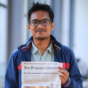 photo of intern holding San Francisco Chronicle