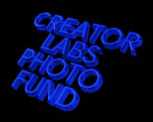 A blue, three-dimensional text on a black background reads, "2023 Creator Labs Photo Fund." The letters are bold and shiny, casting subtle shadows.