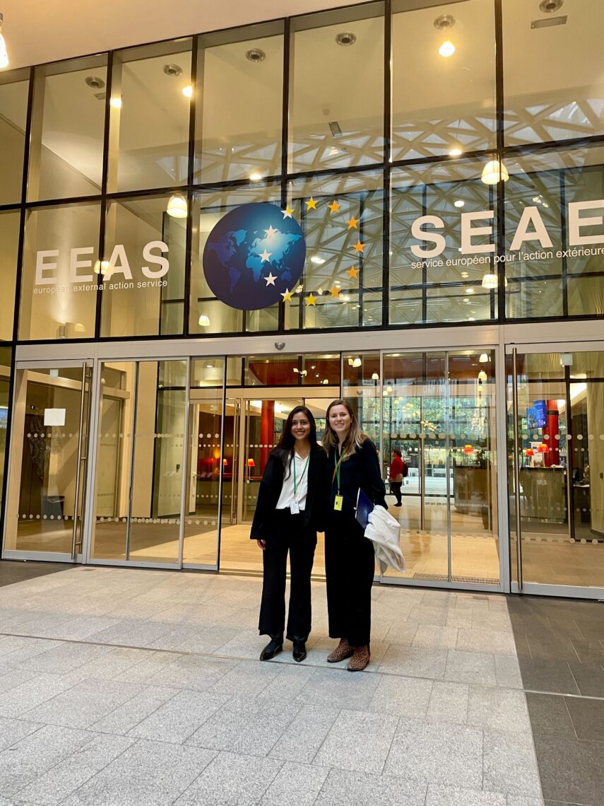 Photo of journalism graduate students Coral del Mar Murphy Marcos and Kelsey Oliver standing in front of an EU building.