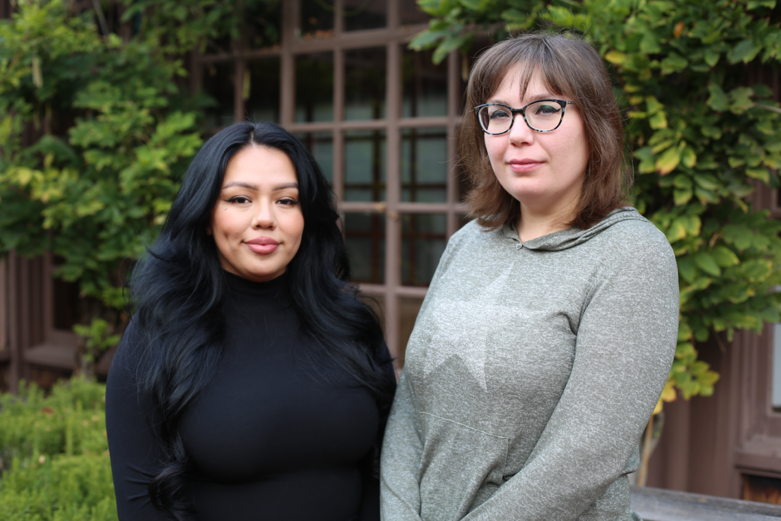 Journalists Ana Tellez-Witrago and Andrea Madison standing next to one another in the courtyard of North Gate Hall.
