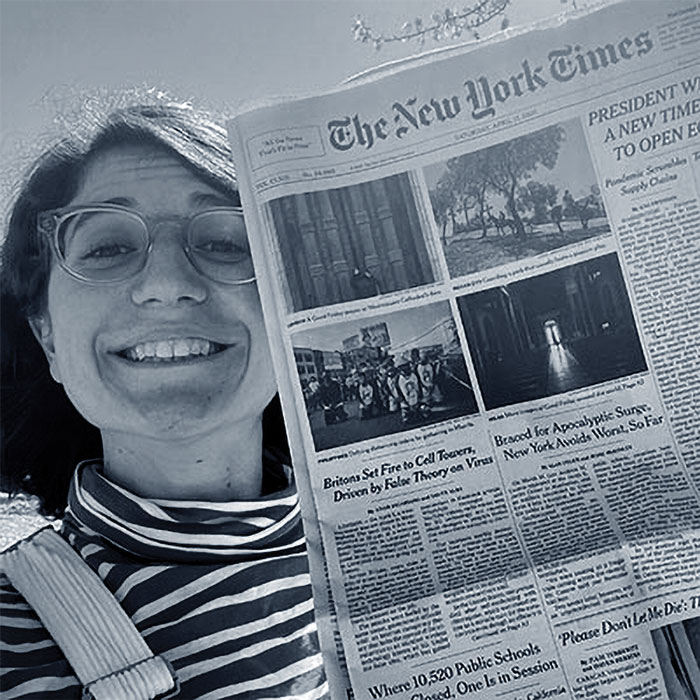 journalism student holding their article that was published in the New York Times