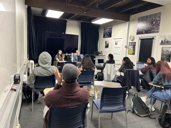 Students talk in business reporting class with Tom Giles.