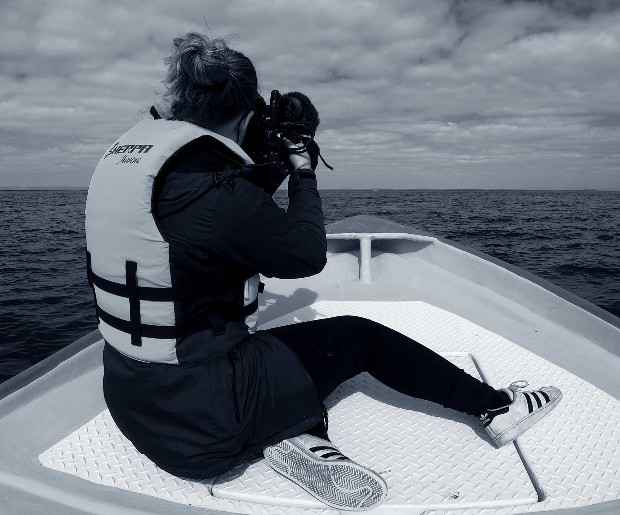 woman in boat with camera