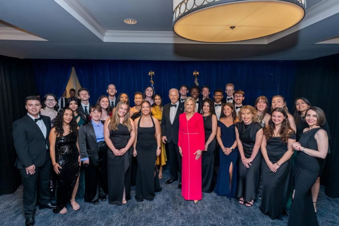 Coral Murphy Marcos and Negar Ajayebi (far right) pose in a group photo of scholars at the annual White House Correspondent's dinner in Washington with President Joe Biden and First Lady Jill Biden.