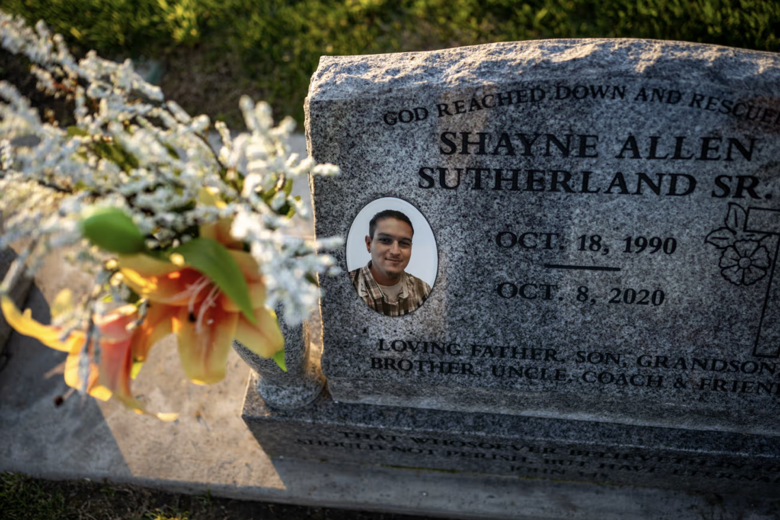 A granite headstone with a photo and flowers commemorates Shayne Allen Sutherland Sr., a dedicated Californian, born 1990 and died 2020.