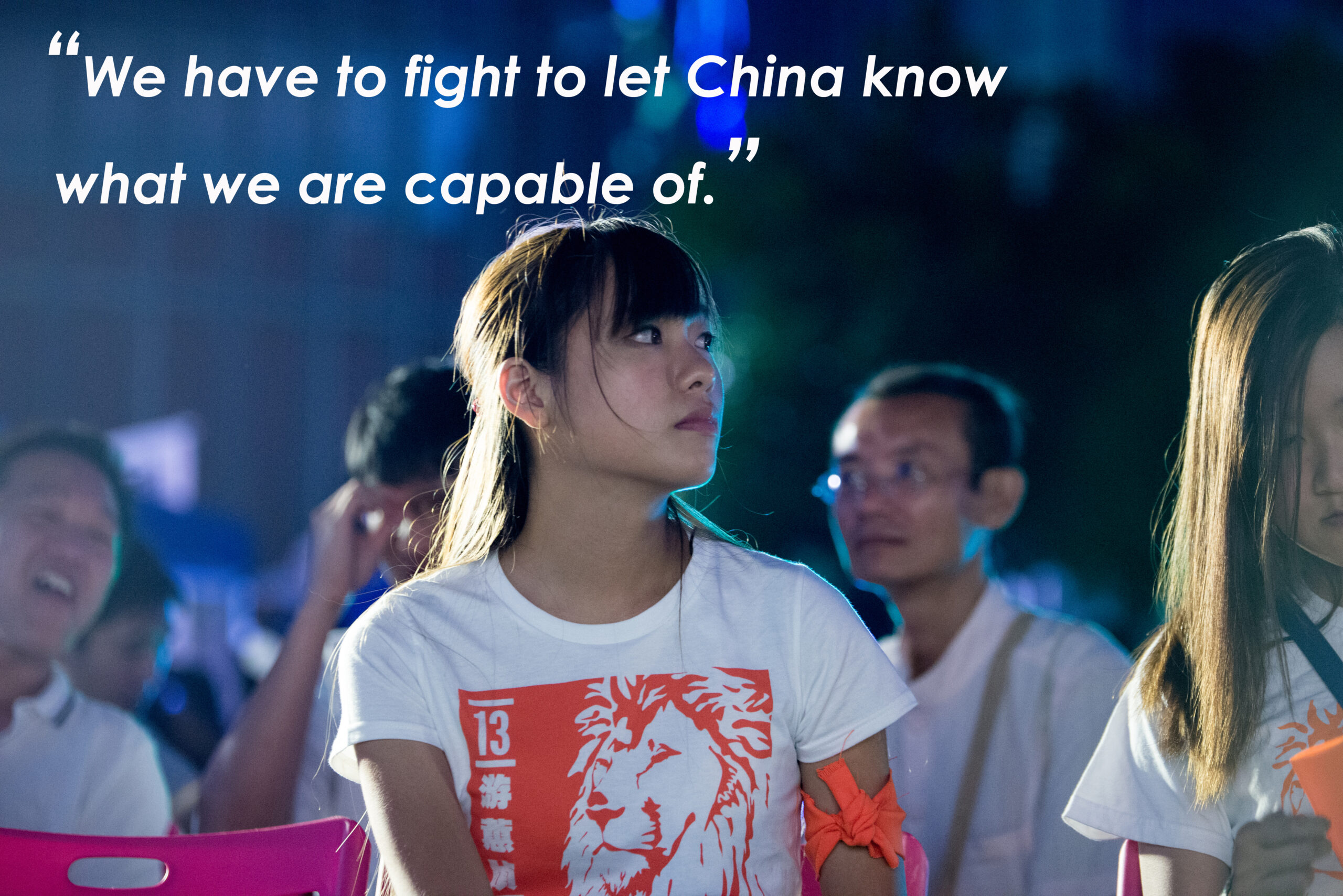 Photo of a young woman wearing a t-shirt with a quote in white above her.