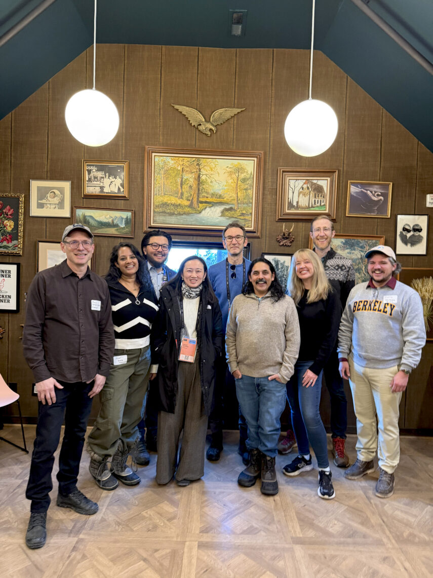 A group of UC Berkeley alumni poses together in a rustic room at the Sundance Film Festival.