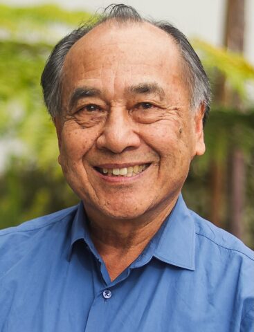 Man in a blue shirt smiling. A headshot of Bruce Koon.