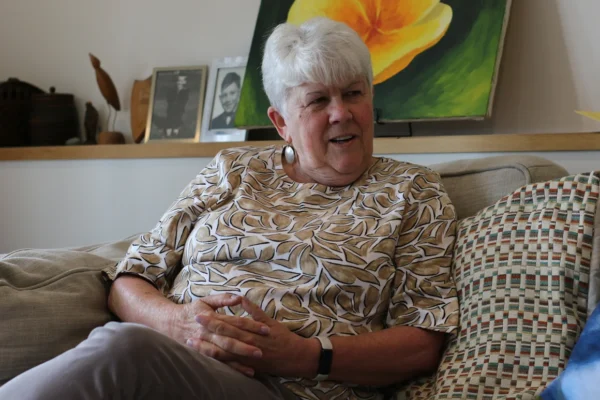Photo of Linda Tung, she has short white hair and is wearing a patterned blouse.