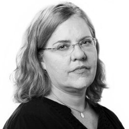 Jennifer LaFleur, a woman with medium-length wavy blonde hair and glasses, is looking into the camera. She is wearing a dark blouse and a necklace against a plain white background.